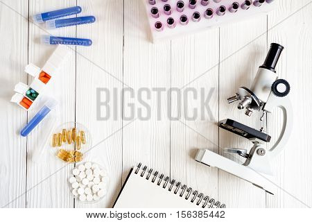 workplace lab assistant with microscope at the clinic top view no one