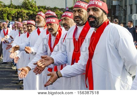 Istanbul Turkey - October 11 2016: Turkish Shia men take part in commemorations marking the mourning period of Ashura. The participants in the memorial services wear the names of martyrs on bands around their foreheads. Turkish Shia Muslims mourning for I