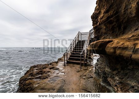 Storm clouds over the Sunset Cliffs surfer ocean access staircase in San Diego, California.