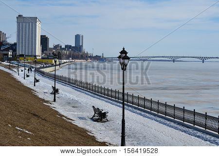 River bank at the end of winter. Quay in the city of Saratov.
