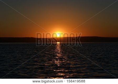 Sunset on the river bank. A hot summer evening. Dramatic sunset.