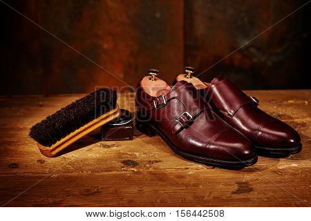 Still life with men's leather shoes and accessories for shoes care