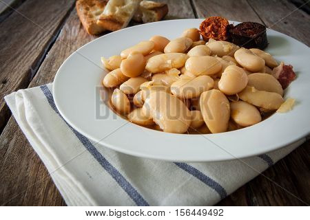 fabada is a typhical spanish legumes dish with big beans and sausage