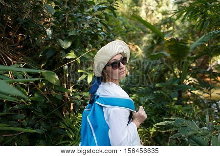 Young traveler with backpack in the jungle. Discovery concept. Travel