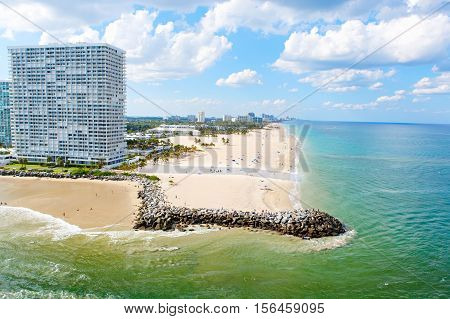 Aerial view of Miami South Beach, Florida, USA. With surfers and people taking bath and swimming.