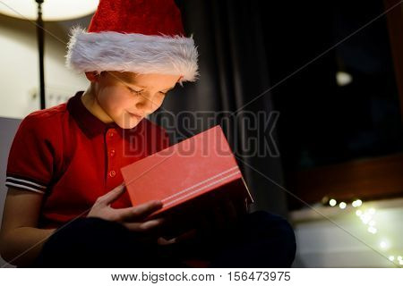 Child Opening Gift Box From Santa Claus.