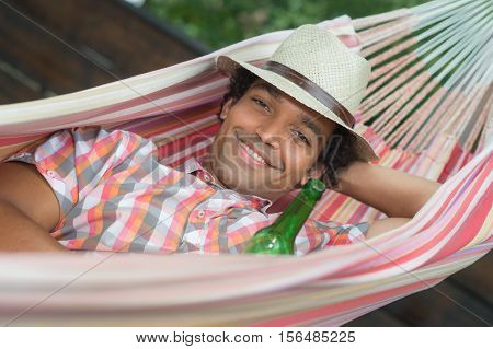 Man Relaxing and drinking a beer In Hammock France