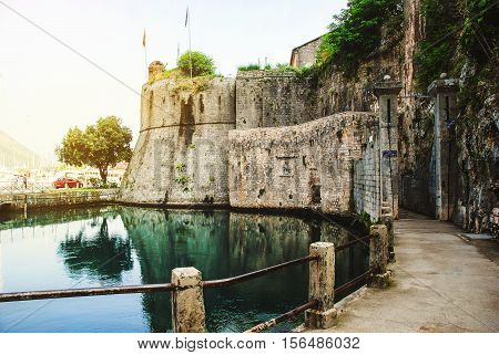 Entrance to the Old Town of Kotor Montenegro during the day. Popular landmark with reflection in the water