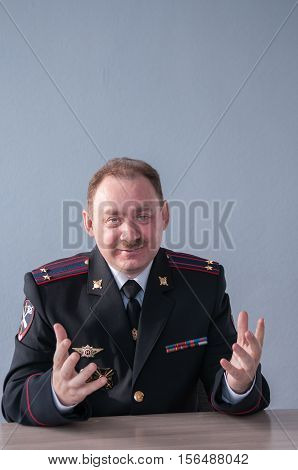 A man in a police uniform showing thumbs up