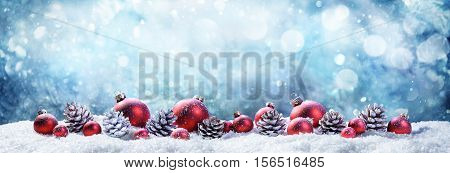 Snowy Christmas Balls And Pinecones In Wintery Scene