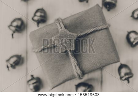 Christmas composition.Present box with twine and craft paperacorns.Top view.Mokup with space.Black and white.Toned