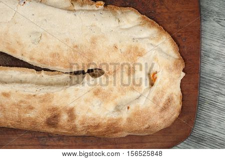 Georgian lavash with greenery and paprika on board