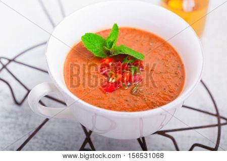 Bowl of fresh tomato soup gazpacho on the table