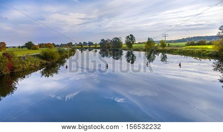 reflection of trees in river tauber, in Bavaria, Germany