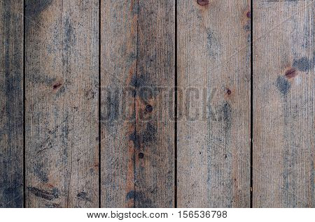Rustic shabby wooden floor of non-painted vertical planks closeup background