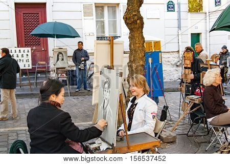 PARIS FRANCE, circa April 2016. Place du tertre in Montmartre. Close to the cathedral of the sacre coeur. The square du tertre is a meeting place of artists very visited by the tourists to take portraits in the moment