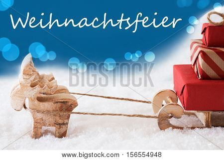 German Text Weihnachtsfeier Means Christmas Party. Moose Is Drawing A Sled With Red Gifts Or Presents In Snow. Christmas Card For Seasons Greetings. Blue Background With Bokeh Effect.