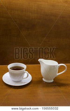 Porcelan cup of tea on the brown table