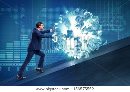 Businessman pushing away dollar ball