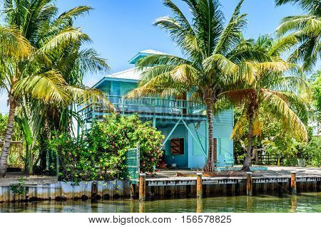 Placencia, Belize - August 28 2016: Tropical waterside house on lagoon side of Placencia in Belize, Central America