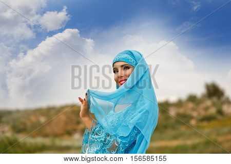 Oriental beauty Sa'idi dance. Nice girl dressed in national costume dancing shepherdess with shepherd's cane outdoors. Nomads.