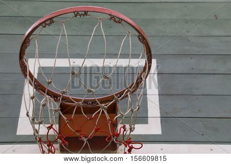 Old dirty outdoor basketball hoop in the park