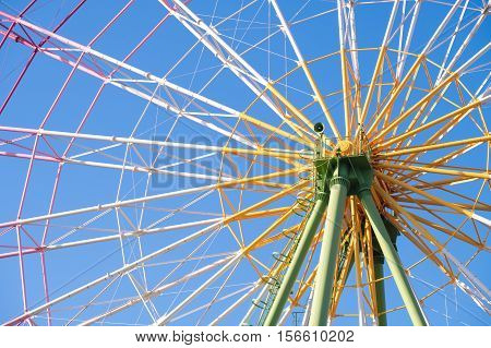 Ferris wheel close up with blue sky in amusement park