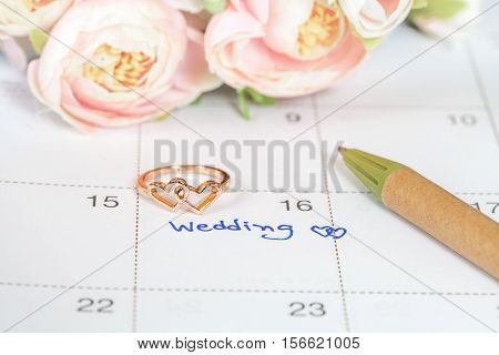 Wedding note on a calendar sets a reminder for the wedding day