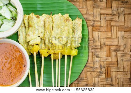 Grilled Pork Satay With Peanut Sauce And Vinegar On Woven Bamboo Background, Thai Food.