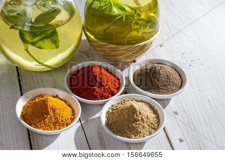 Close-up Of Different Spices And Bottles Of Olive Oil