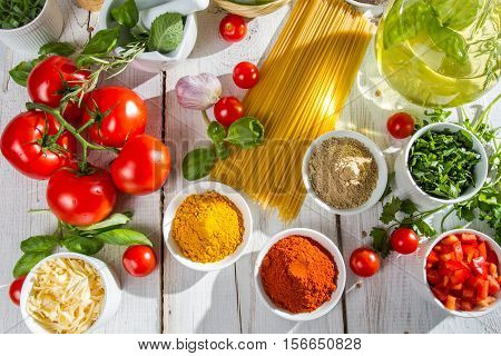 Spices and scents of Italian cuisine on old wooden table