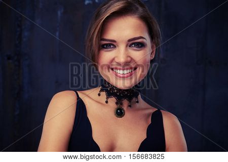 Close-up fashion shot of a stunning woman in luxurious eveningwear. Beautiful mysterious brunette lady portrait