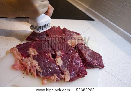 Beef Cooking in the kitchen. Chop meat