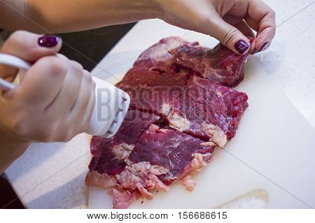 Beef Cooking in the kitchen. Chop meat