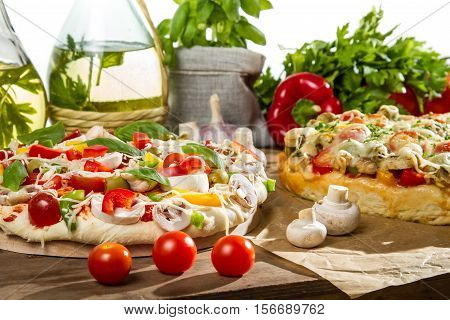 Fresh vegetables for baking pizza on old wooden table