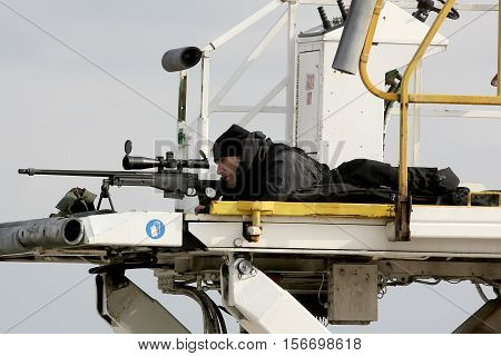A Sniper Aims His Weapon Securing The Area As President Barack Obama