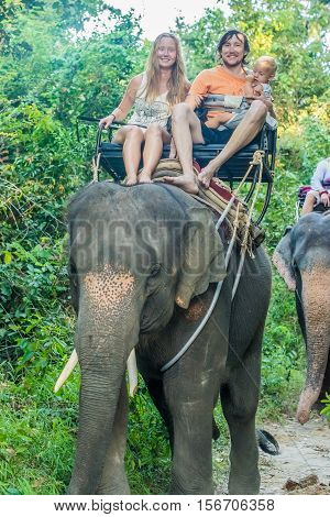 Happy Family Riding On An Elephant