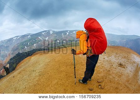hiker on the trail in the Islandic mountains. Trek in National Park Landmannalaugar, Iceland