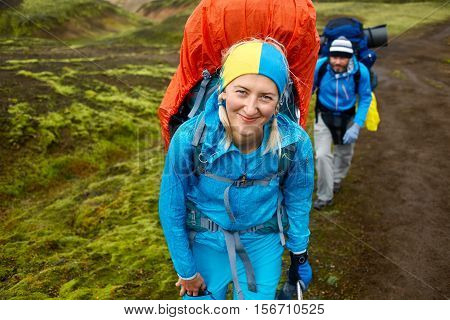 hikers on the trail in the Islandic mountains. Trek in National Park Landmannalaugar, Iceland
