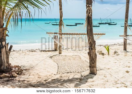beautiful colorful seascape with hammock and palm on a beach