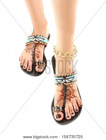 Female legs with henna tattoo, isolated on white