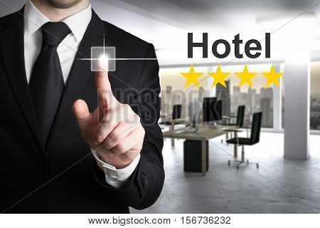 businessman in modern office pushing touchscreen hotel rating stars