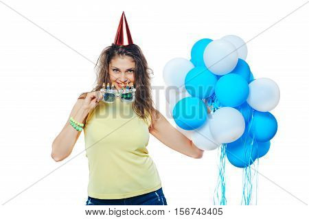 Girl with balloons and a red cap sun glasses with congratulations on the birthday