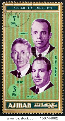 AJMAN - CIRCA 1971: a stamp printed in Ajman shows Shepard Roosa and Mitchel Astronauts Apollo 14 circa 1971