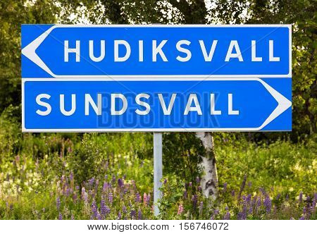 Swedish signpost for directions to the two towns Hudiksvall and Sundsvall.