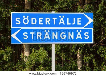 Signpost with direction to the two Swedish citys Sodertalje and Strangnas.