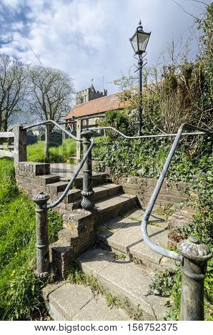 Steps leading to Brede village churchyard Kent UK