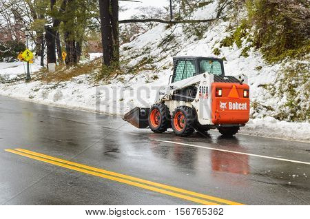 Charlottesville, USA - March 6, 2013: Bobcat snow removal truck on road in winter