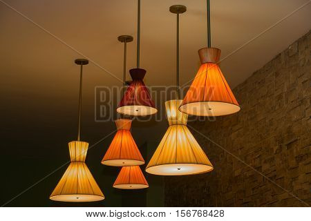 Great amzing closeup view of cones shaped vintage retro style electrical ceiling lights at night