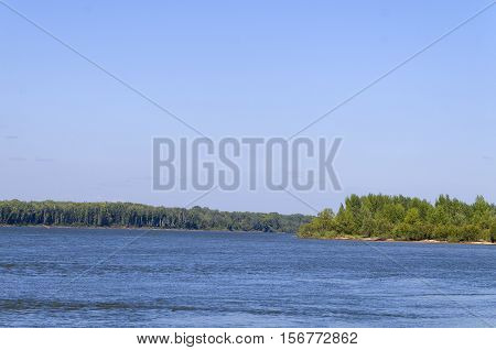 island covered with green forest on a large river